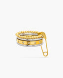 Piper mixed-metal stacked ring with beaded gold bands, clear stones and a safety-pin accent on a white background.