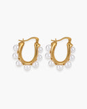 Pair of sculptural gold-tone hoop earrings accented with graduated white pearl-like beads.