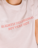 White cropped tee reading Slightly Delusional But Very Hot.