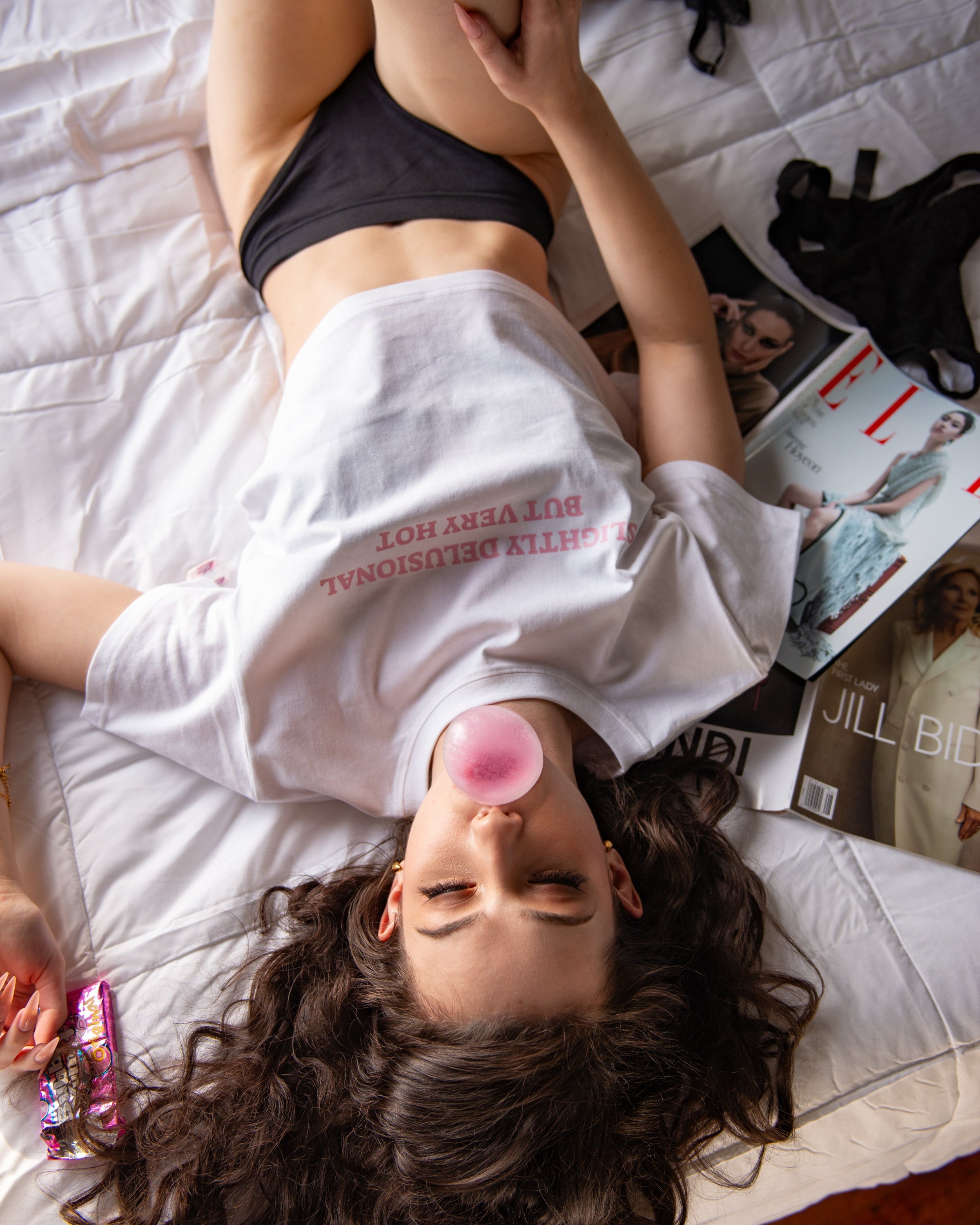 Additional lifestyle view of the white Slightly Delusional But Very Hot cropped tee.