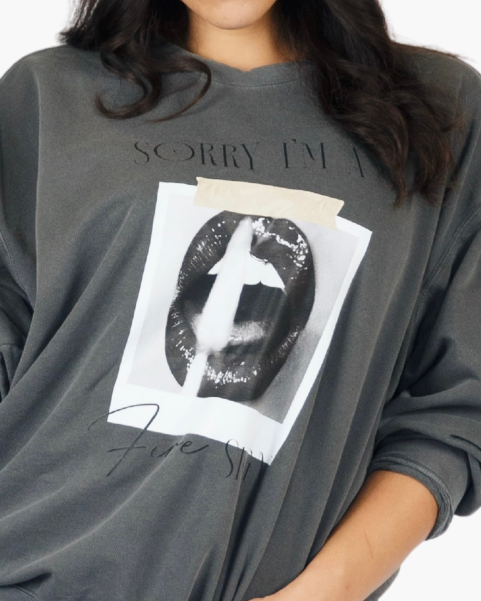 Washed charcoal crewneck sweatshirt reading Sorry I’m a Fire Sign with a black-and-white lips graphic.