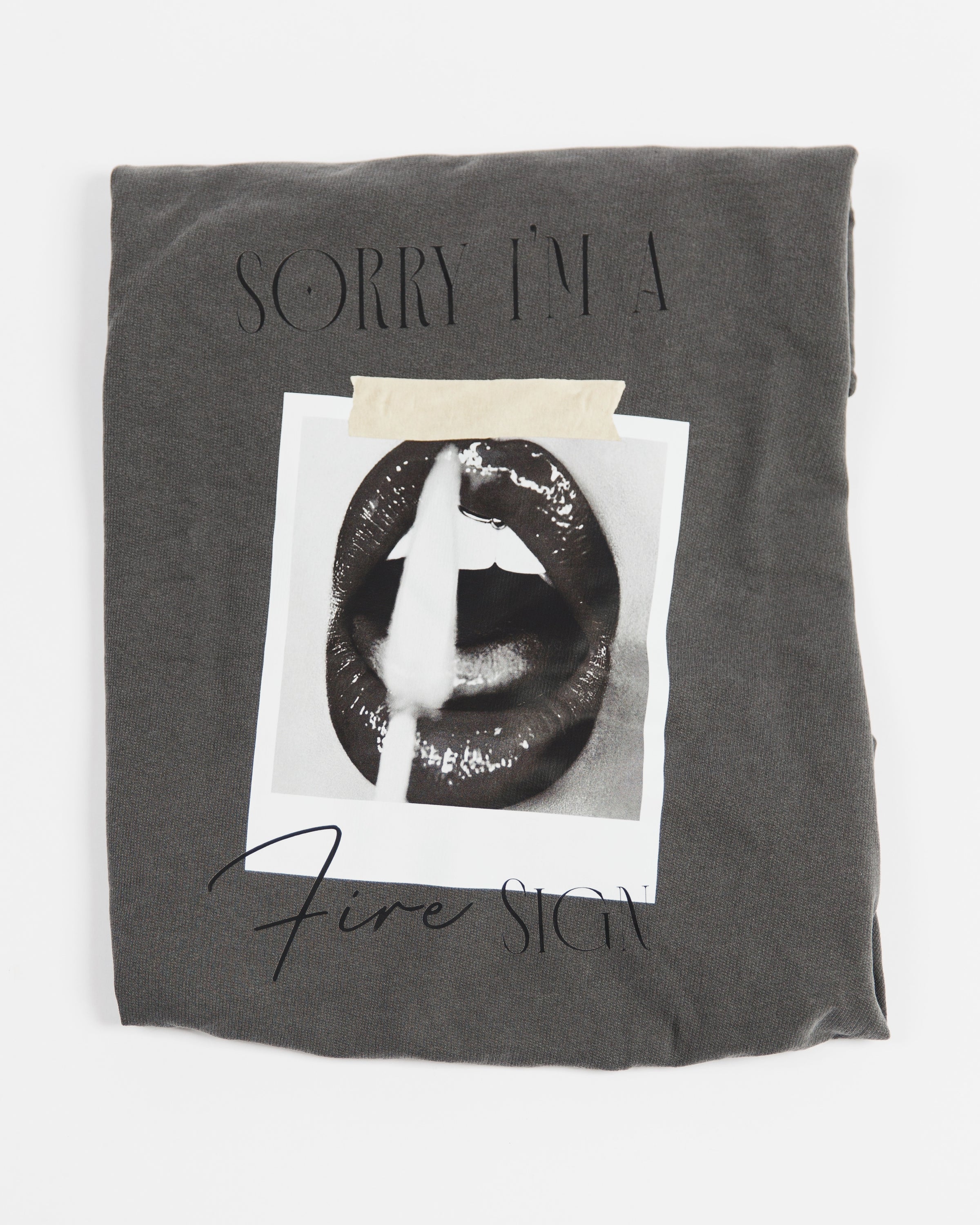 Folded washed charcoal Sorry I’m a Fire Sign crewneck sweatshirt.