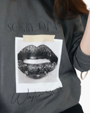 Washed charcoal crewneck sweatshirt reading Sorry I’m a Water Sign with a black-and-white lips graphic.