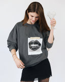 Model wearing the washed charcoal Sorry I’m a Water Sign crewneck sweatshirt.
