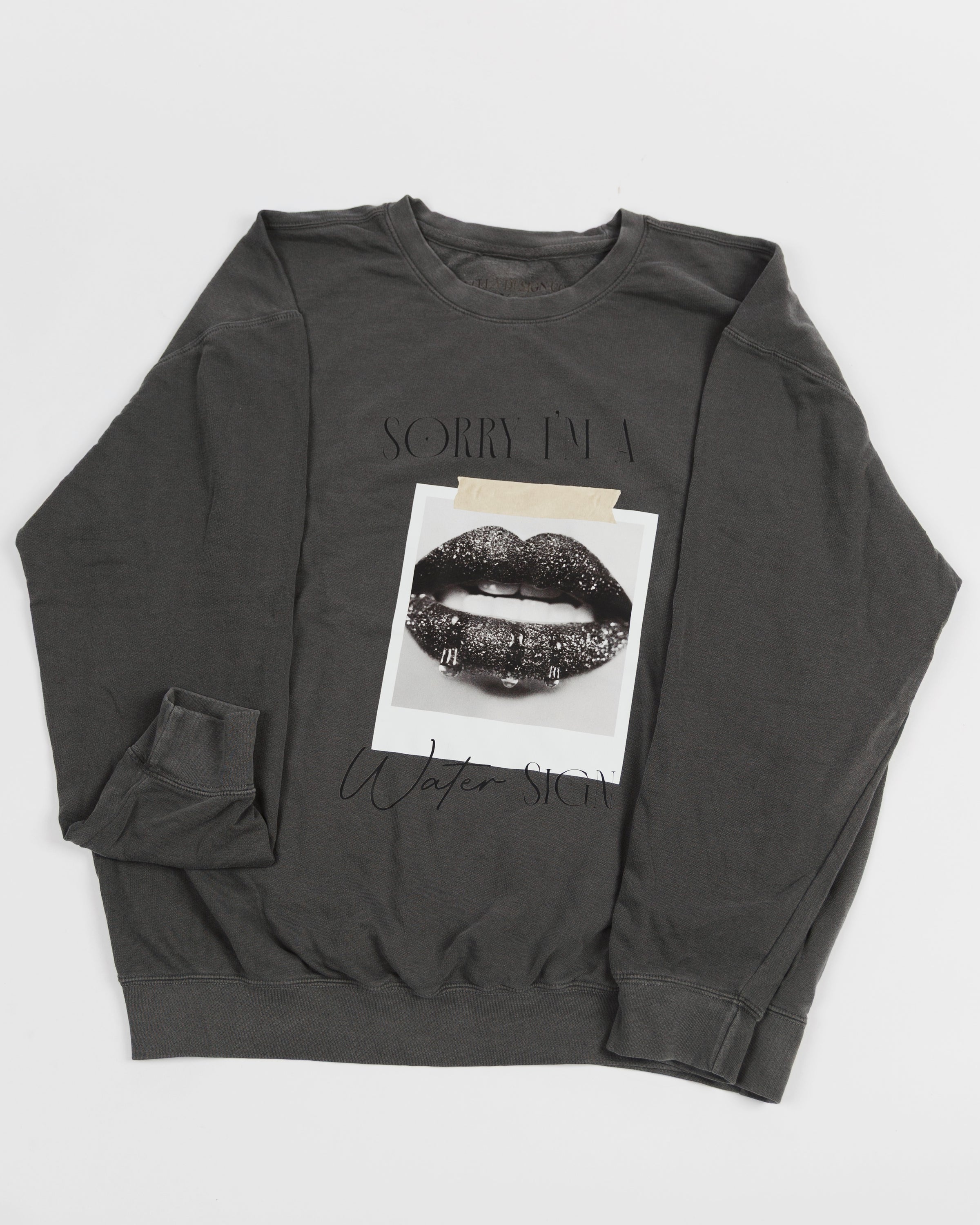 Washed charcoal Sorry I’m a Water Sign crewneck sweatshirt laid flat.
