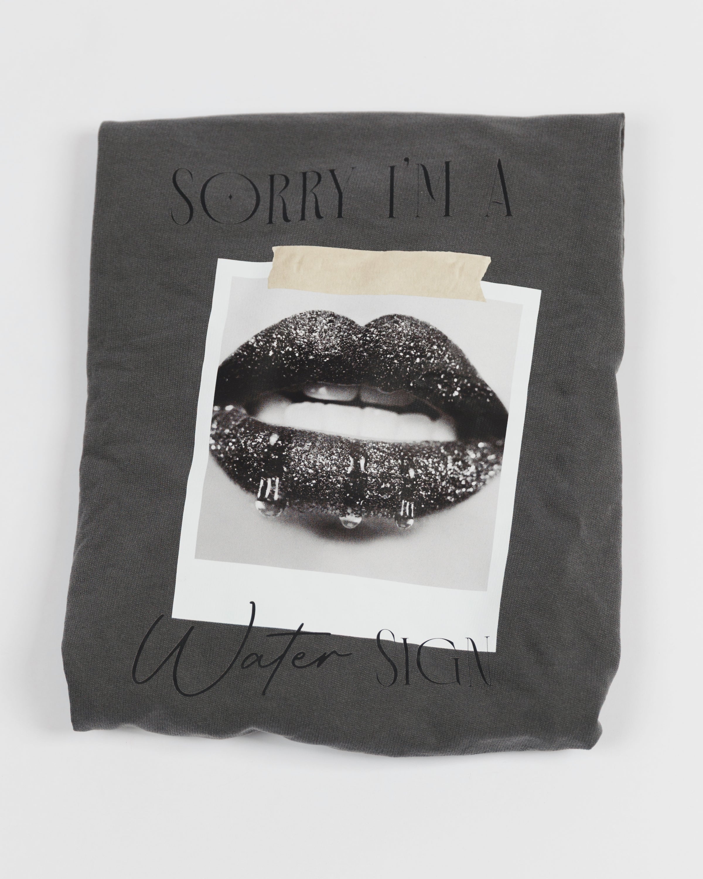 Folded washed charcoal Sorry I’m a Water Sign crewneck sweatshirt.
