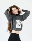 Model wearing the washed charcoal Sorry I’m an Air Sign crewneck sweatshirt.