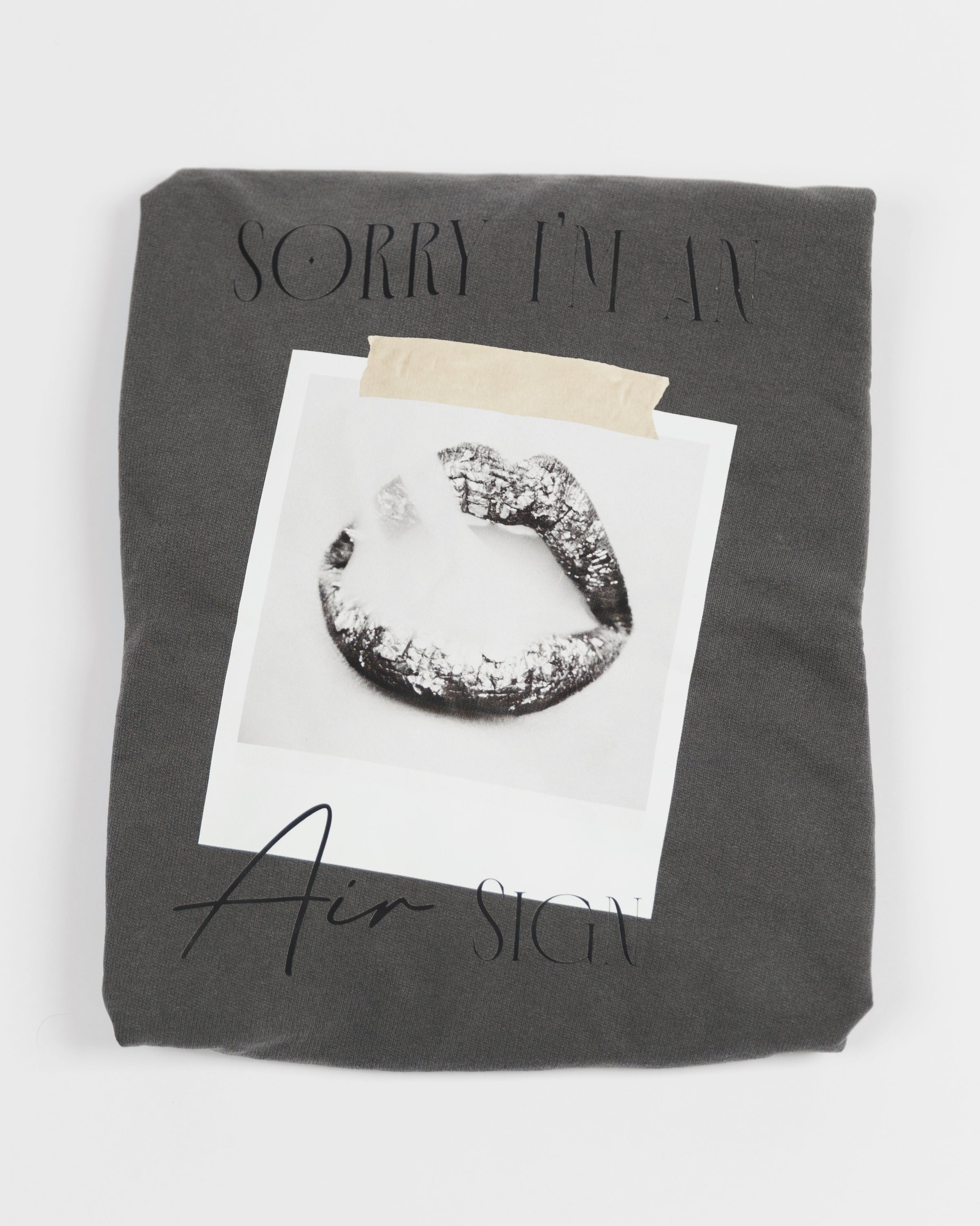 Folded washed charcoal Sorry I’m an Air Sign crewneck sweatshirt.