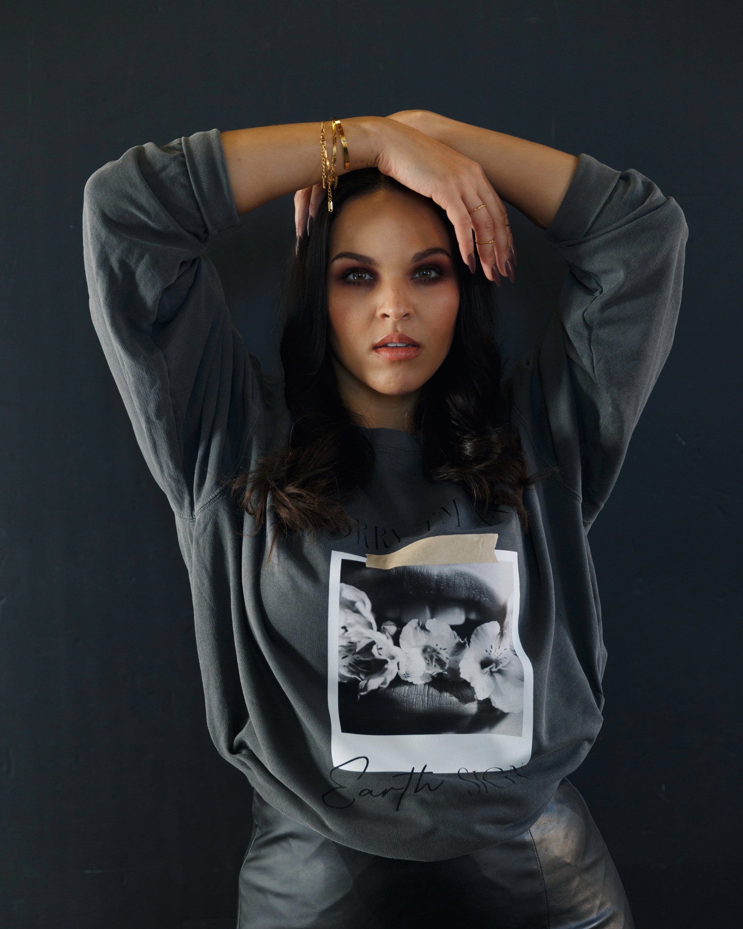 Model wearing the washed charcoal Sorry I’m an Earth Sign crewneck sweatshirt.