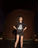 Lifestyle view of the black TROUBLE graphic T-shirt.