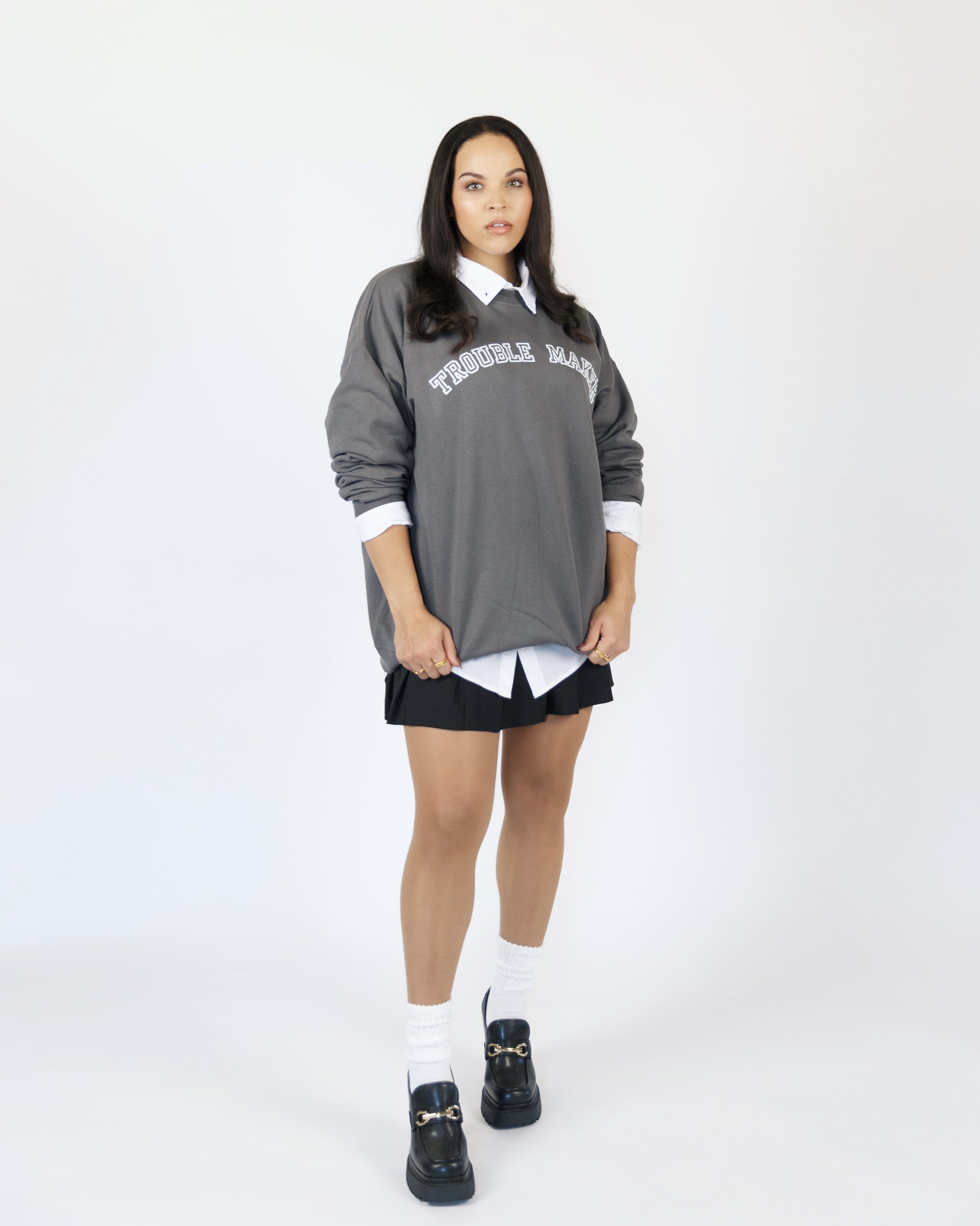 Supporting image of the charcoal Trouble Maker crewneck sweatshirt.