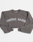 Charcoal Trouble Maker crewneck sweatshirt worn by a model.