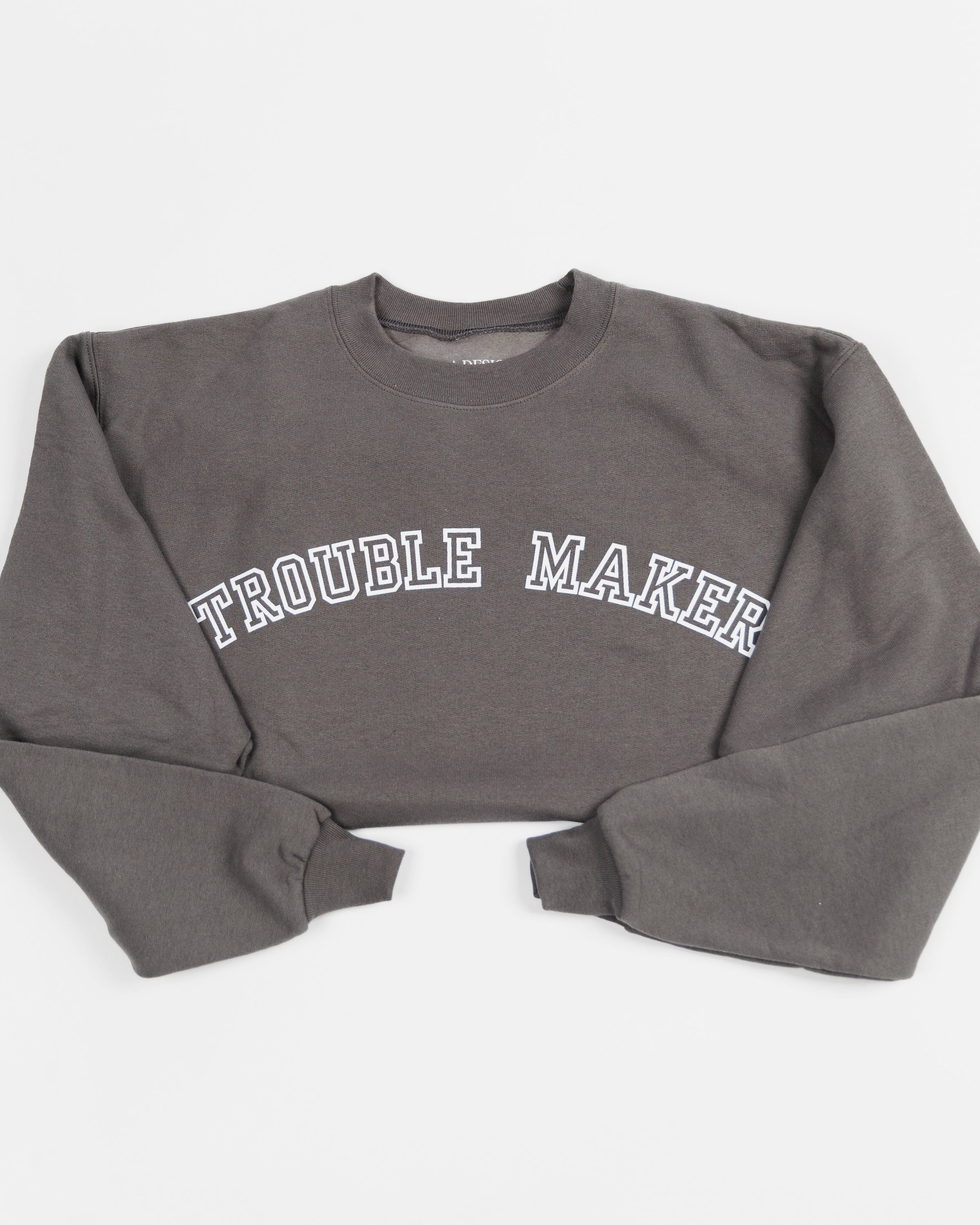 Charcoal Trouble Maker crewneck sweatshirt worn by a model.