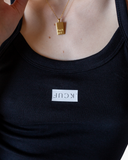 Black fitted camisole tank with inverted FUCK graphic.