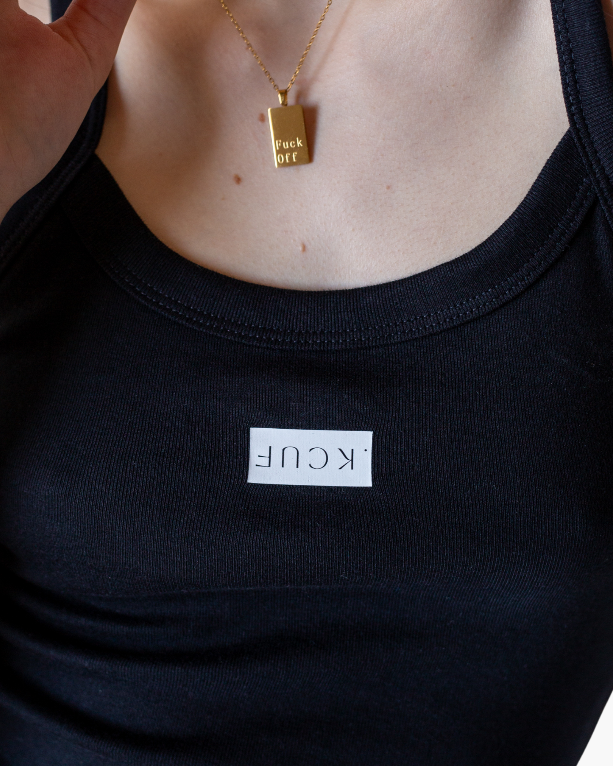 Black fitted camisole tank with inverted FUCK graphic.
