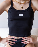 Alternate view of the black upside-down Fuck camisole tank with white chest graphic.