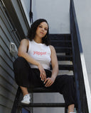 Model wearing the white Yapper cropped tank with bold red lettering.