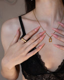 Zenobia Necklace worn against the neckline, hover view.