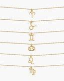 Gold zodiac necklaces for Aries through Virgo arranged on a white background.