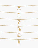 Gold zodiac necklaces for Libra through Pisces arranged on a white background.