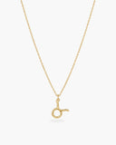 Gold-tone Taurus zodiac pendant necklace on a fine adjustable chain.